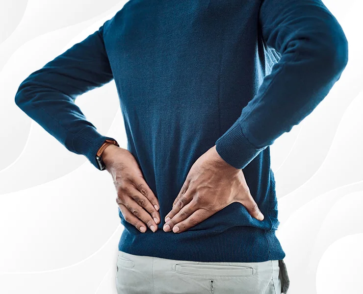 Male touching his lower back in pain | Pain Management | Interventional Spine and Pain Associates